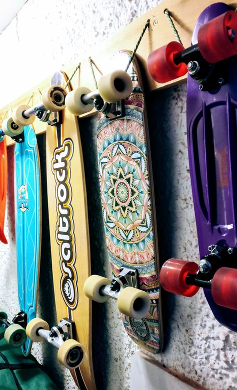 Skateboard storage: plank of wood screwed into wall. Holes in the wood, with rope tied through for hanging the boards on. Cheap, easy and shows off the boards fancy bottoms too! Garage Skateboard Storage, Skate Board Storage Ideas, Hanging Skateboards On Wall Diy, Skate Board Storage, Skateboard Wall Mount Diy, Hang Skateboard On Wall, How To Hang Skateboards On Wall, Skateboard Rack Wall Mount, Skateboard Hanging On Wall