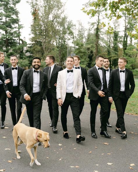 Tux Styles Wedding, Groomsmen In White Tuxedos, White Tux Wedding Bride Groom, Groom White Tuxedo With Groomsmen, Groomsman Tux Ideas, Black And White Suit Wedding, Groomsmen Attire Classic, Groom In White Groomsmen In Black, More Groomsmen Than Bridesmaids