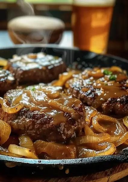 Hamburger Steaks with Onion Gravy - MmmRecipes : Easy and Delicious Recipes Hamburger Steaks With Onion Gravy, Pepper Steak And Onions, Bacon Cheeseburger Meatloaf, Mini Crockpot Recipes, Beef Tips And Noodles, Cheeseburger Meatloaf, Baked Meatloaf, Hamburger Steaks, Mexican Casserole Recipe