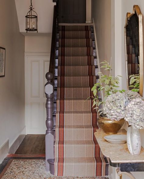 Anna Haines Design Ltd on Instagram: "A hallway from a recent project. We painted the stairs, newel post and spindles in a bitter chocolate which sits nicely against the teracotta tones of the stair runner we sourced, and of the terrazzo floor. The console and the mirror are handsome Italian mid century pieces which I think give a touch of glamour as the clients walk into their home! 📸 @paul_whitbread_photo" Painted Stairs And Runner, Anna Haines, Edwardian Hallway, Terrazzo Floor, Hall Carpet, Bitter Chocolate, Painted Stairs, Newel Posts, Terrazzo Flooring