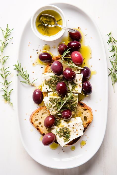 Indulge in a Mediterranean delight! Our Herb-Marinated Feta with Roasted Grapes on Crostini is the perfect fusion of tangy, sweet, and crunchy. A must-try appetizer! #MediterraneanCuisine #FetaCheese #RoastedGrapes #CrostiniLove #AppetizerGoals Mediterranean Canapes, Mediterranean Food Photography, Appetizer Photography, Feta Appetizer, Canape Ideas, Cheese Aesthetic, Feta And Olives, Marinated Feta, Mediterranean Appetizers