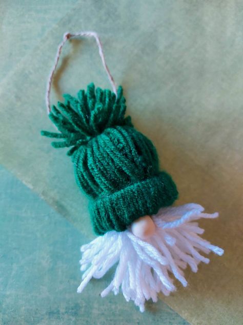 DIY Yarn Santa Ornament – The Expert Amateur Small Yarn Hat Ornaments, Yarn Hats With Toilet Paper Rolls Santa, Santa Hat Ornaments Diy Christmas, Yarn Beanie Ornament, Mini Yarn Hats Christmas Ornament, Santa Yarn Ornament, Santa Head Ornaments, Toilet Paper Roll Santas With Yarn, Yarn Hat Ornaments Diy