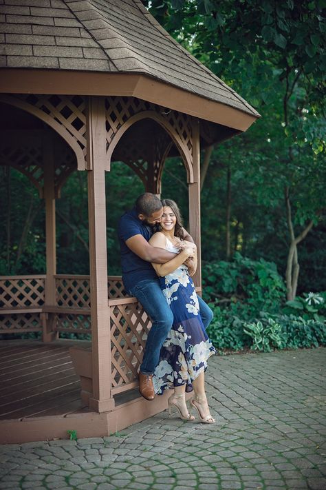 Shelby Township Michigan Garden Engagement embrace smiling, maurice sitting on gazebo ledge and genevieve standing Photo: Holly Green Gazebo Pictures, Michigan Garden, Michigan Gardening, Central Michigan University, Garden Engagement, Michigan University, Engagement Pictures Poses, Couples Engagement Photos, Photographs Ideas