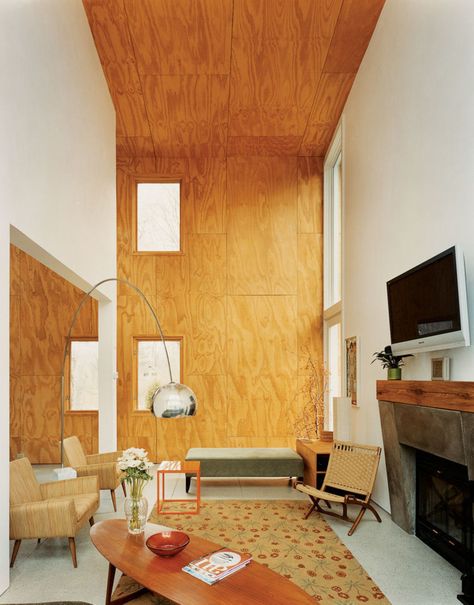 A double-height living area clad in unfinished plywood, in Connecticut. (Photo… Plywood Interior Walls Living Room, Ply Wood Wall Ideas, Plywood Fireplace, Plywood Living Room, Plywood Interior Design, Plywood Interior Walls, Plywood Accent Wall, Plywood Bedroom, Plywood Room