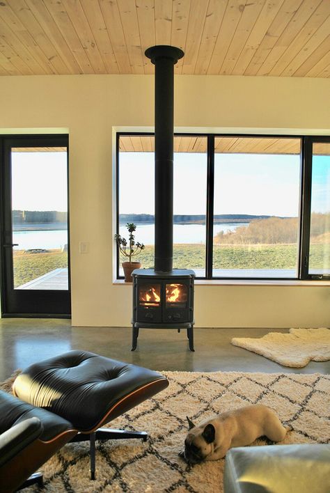 Wood Burning Stove In Front Of Window, Wood Stove In Front Of Window, Scandinavian Cottage, Passive Solar Heating, Pine Tar, Burned Wood, Wood Heat, Net Zero, River Road