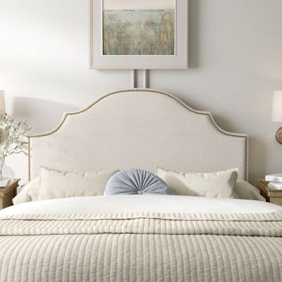 Make your bed the centerpiece to your bedroom with this panel headboard. Handmade in the USA with a solid and engineered wood frame, this headboard is fully upholstered with a linen blend and filled with foam for a plush, inviting look. Its gently arched silhouette also features angled cutouts and is dotted by nailhead trim. When it arrives, you can attach this headboard to the bed frame of your choice, mounting hardware included. Hand-curated by Kelly Clarkson. Upholstery: Talc, Size: Queen | K Ivory Fabric Headboards, Farmhouse Chic Bedroom Fabric Headboard, Coastal Headboard Fabric, Wall Color For Ivory Upholstered Bed, Upholstered Headboard Ashley Furniture, Head Boards Fabric, Beautiful Headboards Overstock, Headboards Queen Fabric, Upholstered Button Headboards For Beds