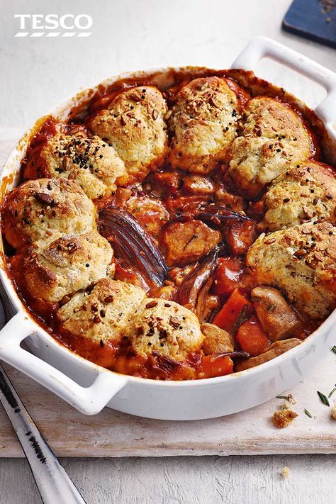 Take a simple winter stew up a notch by topping with simple seeded scone dumplings – in the oven these go golden and crisp on top, whilst soaking up all the flavours of the rich pork and pesto stew underneath. | Tesco Stew Dumplings, Gaz Oakley, Savoury Scones, Mains Recipes, Stew And Dumplings, Recipe Pork, Red Pesto, Vegan Stew, Pork Fillet