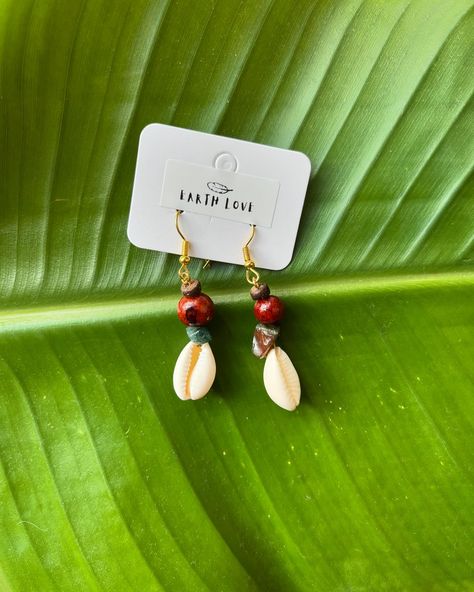 New to Earth Love 🤍✨ Obsessed with these new earrings! Featuring feathers, cowrie shells, açaí beads, coconut beads, and crystals, each piece is delicate and beautiful. ✨ All handcrafted by me with love. 🤍 #EarthLoveJewelry #HandcraftedJewelry #EarringDesigns #BohoEarrings #Feathers #CowrieShells #AcaiBeads #CoconutBeads #CrystalJewelry #UniqueEarrings #JewelryWithMeaning #HandmadeWithLove #SustainableFashion #EcoFriendlyJewelry #FashionAccessories #ArtisanMade #JewelryAddict #ShopSmall #Su... Beach Shell Earrings Made Of Cowrie, Handmade Dangle Shell Earrings, White Shell-shaped Cowrie Shell Earrings, Bohemian Jewelry With Shell-shaped Cowrie Shell, Beach Cowrie Shell-shaped Earrings, Cowrie Shells, New Earrings, Eco Friendly Jewelry, Cowrie Shell