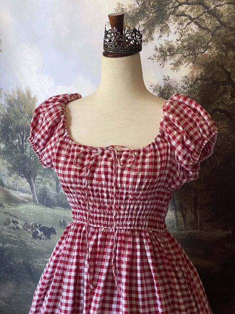 Be the countryside maiden of your dreams in this stunning Gingham Puff-Sleeve Maxi Dress. Featuring a fully-shirred bodice, bardot-style cinched milkmaid neckline, adjustable puff-sleeves, dainty bow-tied chest ribbon, and a sweeping half-circle skirt silhouette; this dress is the perfect summer-to-autumn uniform. From picking apples in the orchard, to baking pies in your cottage, this dress has you covered! Sizing: ✧IN✧ Bust Waist Hips Length S 28-42 In. 26-38 In. 80+ In. 45 In. M 32-44 In. 28- Milkmaid Dresses, Gingham Dresses, Baking Pies, Picking Apples, Milkmaid Dress, Fantasy Shop, Countryside Cottage, Bardot Style, Apple Dress