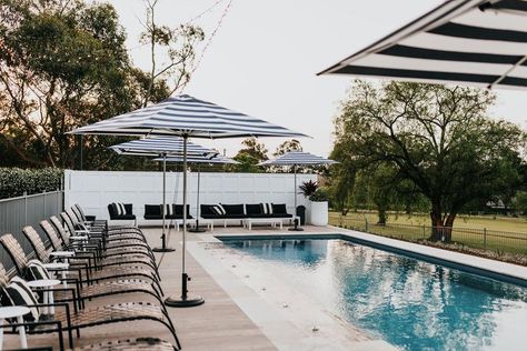 Resort style swimming pool surrounded by striped umbrellas, deck chairs and countryside at a private property available for wedding hire near Sydney. Wedding Venues Nsw, Sydney Wedding Venues, Greystone Estate, Private Property Wedding, Cheap Wedding Reception, Wedding Venues Sydney, Airbnb Wedding, Cheap Wedding Venues, Event Room