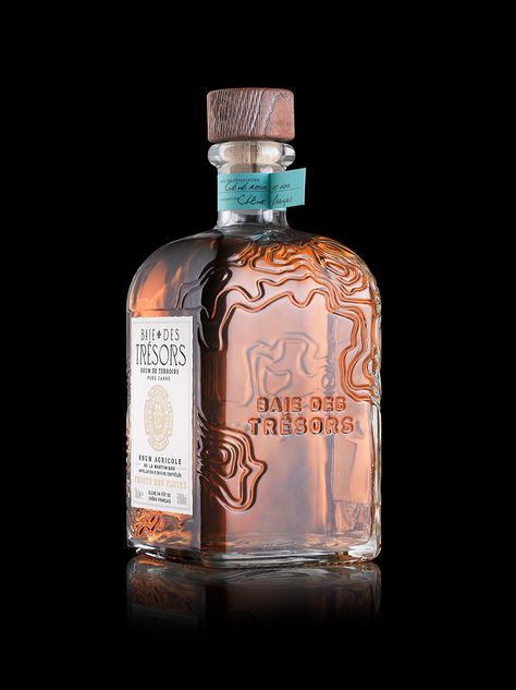 Stranger & Stranger's Intricate Bottle Design For Baie Des Trésors | Dieline - Design, Branding & Packaging Inspiration Spirits Bottle Design, Spirits Packaging Design, Alcohol Packaging Design, Whiskey Packaging, Wine Bottle Design, Rum Bottle, Bottle Design Packaging, Alcohol Packaging, Perfume Bottle Design