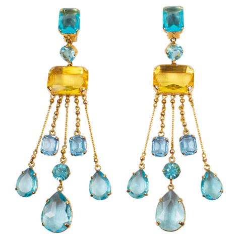 Sophisticated Carlo Zini dangling clip-on earrings. Features an extra-long shoulder-duster geometric shape with gilt metal framing ornate with dangling charms. Aquamarine, turquoise, and yellow topaz crystal rhinestones in pear, round and rectangular shapes. Marked at the back with Zini gilt metal tag. Measurements: 1.57 in. wide (4 cm) x 5.94 in. high (15 cm). Topaz Crystal, Metal Tag, French Jewelry, Art Ancien, Aesthetic Rooms, Earring Display, Pearl Earrings Dangle, Antique Earrings, Accessories Jewelry Earrings