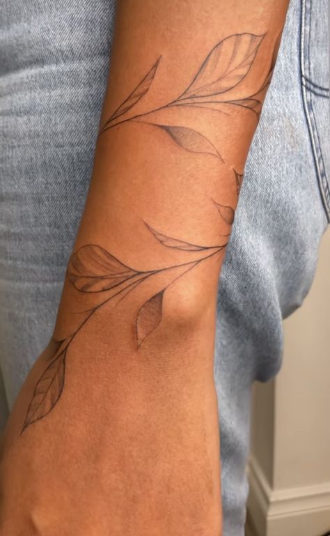 Fine Line Leaf Tattoo Arm, White Vine Tattoo, Leaves Around Wrist Tattoo, Vine With Words Tattoo, Wrap Forearm Tattoo Women, Vine Tattoo On Forearm, Wrist Leaves Tattoo, Vines Going Up Arm Tattoo, Leaf Arm Tattoos For Women