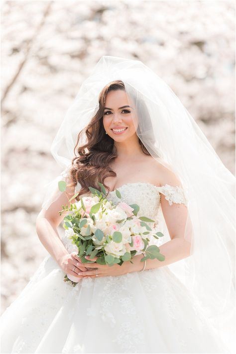 bride holds bouquet of pink and white flowers in Newark NJ by cherry blossoms | The Palace at Somerset Park wedding with fireworks display and cherry blossom portraits photographed by Idalia Photography associate team. Plan a romantic spring wedding with pink details - find ideas here! Cherry Blossom Portrait Photo Ideas, Flowers Around Brides Face Photo, Cherry Blossom Wedding Photoshoot, Bride Holding Bouquet, Garden Bridal Portraits, Castle Bridal Photography, Romantic Spring Wedding, Ny Wedding Venues, Pa Wedding Venues