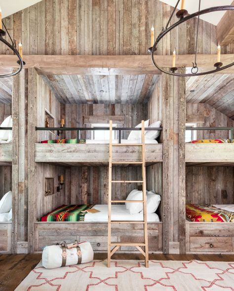 This bunk bed room may fit a ton of guests to this cabin, but it also has a cozy feel thanks to functional built-ins and wrought-iron railing. Instead of traditional twin- size bunk beds, the homeowners decided to build six queen-size versions. The room also contains two twin beds, bringing the sleeping total in this space alone to 14 people. Talk about a slumber party! Bunk Room Ideas, Bunk Bed Room, Bunk Bed Rooms, Modern Bunk Beds, Built In Bed, Built In Bunks, Bunk Rooms, Log Cabin Decor, Bunk Room