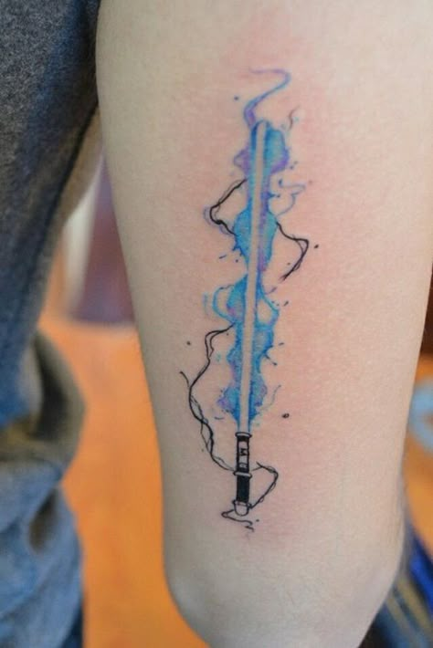 Star Wars Tattoos Designs (33) Wand And Lightsaber Tattoo, Star Wars Watercolor Tattoo, Nerdy Matching Tattoos, Lightsaber Tattoos, Small Star Wars Tattoo, Nerd Tattoo Ideas, Lightsaber Aesthetic, Pride Tattoo Ideas, Lightsaber Tattoo