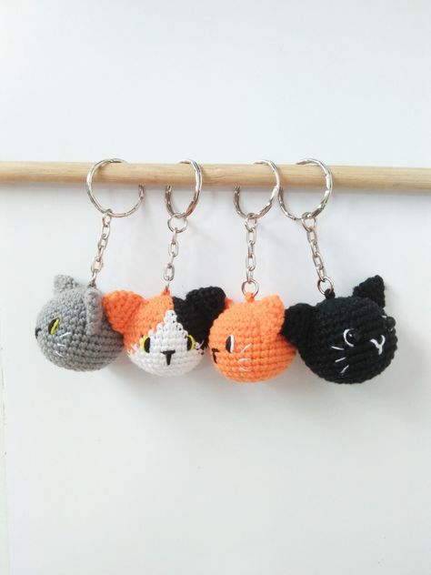 Four crochet cat head amigurumi as a keychain Cat Amigurumi Keychain, Ginger And Black Cat, Crochet Market Stall, Cat Head Crochet, Cat Crochet Keychain, Cat Keychain Crochet, Crochet Key Chains, Crochet Cat Keychain, Black Cat Crochet