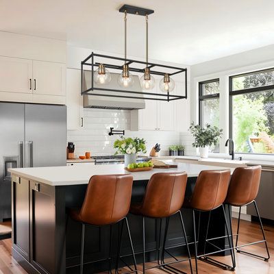 Featuring clean, simple styling, the Mariello 4-light farmhouse kitchen island linear pendant adds a modern look to your space. A beautiful possibility along with a table or an island, this 32.5" elongated frame fixture is oversized and ideal for big spaces. The on-trend black & gold combination finish will also allow the simple fixture to stand out with four 40W bulbs (not included) and illuminate any surroundings without lamp shade shadowing. Everly Quinn Finish: Black/Gold | Everly Quinn Mari Brass Kitchen Island, Intimate Lighting, Armoire Design, Black Farmhouse, Farmhouse Kitchen Island, Kitchen Island Linear Pendant, Modern Kitchen Island, Island Pendant Lights, Kitchen Island Lighting Pendant