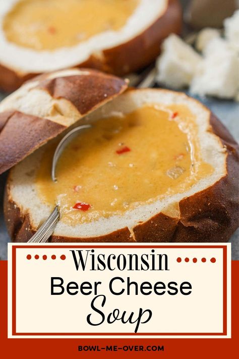 A creamy cheese soup in a bread bowl and spoon. With Pinterest overlay. Beer Cheese Soup Recipes Crock Pot, Cheesy Beer Brat Soup, Slow Cooker Beer Cheese Soup, Best Beer Cheese Soup, Beer Cheese And Brat Soup, Irish Beer Cheese Soup, Easy Beer Cheese Soup, Wisconsin Beer Cheese Soup, Beer Cheese Soup Recipes