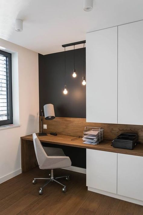 a small and functional home office with a black accent wall, sleek white storage units, a built in desk and a white chair plus bulbs hanging Apartemen Studio, Desain Pantry, Home Office Inspiration, Home Office Table, Office Nook, Office Layout, Trendy Living Rooms, Trendy Bedroom, Home Office Space