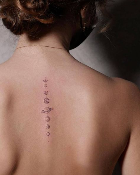 Single needle solar system tattoo on the upper back Subtle Space Tattoo, Universe Tattoo Back, Universe Inspired Tattoos, Solar Tattoo Designs, Fine Line Solar System Tattoo, Small Solar System Tattoo, Spine Tattoos Space, Simple Solar System Tattoo, Planets Spine Tattoo