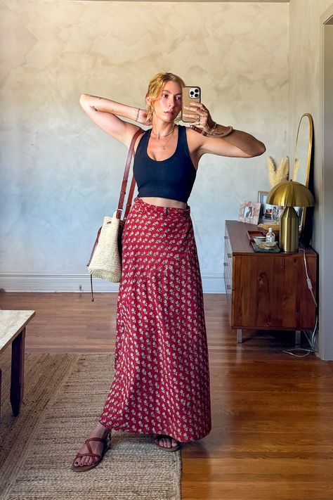 I love this printed wrap maxi skirt for an easy outfit idea. Its one of those versatile pieces that you look like you put a lot of thought into your outfit with little effort. Paired it with a classic cropped tank, strappy leather sandals, and a raffia bucket basket bag. #bohoaesthetic #backtoschooloutfitideas #bohoaestheticoutfit #popofred #summeroutfitideas #maxiskirtoutfit #aestheticoutfits Hankerchief Skirt Outfits, Summer Maxi Skirt With Handkerchief Hem, Handkerchief Skirt Outfit, Hippie Red Maxi Skirt For Festivals, Boho Sandals Outfit, Festival Aesthetic Outfit, Red Hippie Flowy Maxi Skirt, Printed Maxi Skirt Outfit, Thrifted Maxi Skirt