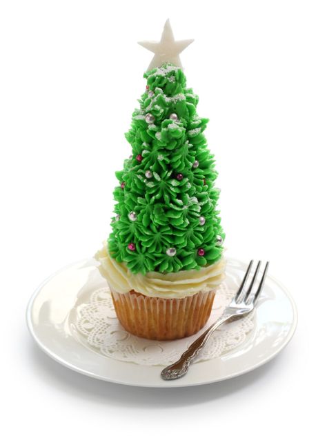 These Christmas Tree Cupcakes are the perfect holiday treat to make for Christmas parties. Made with cupcakes, ice cream cones, frosting and some fun toppings, they are sure to be a conversation starter! #christmastree #christmastreecupcakes #christmascupcakes #treecupcakes #christmaspartyideas Xmas Cupcakes, Tree Cupcakes, Christmas Tree Cupcakes, Sugar Cones, Frosting Tips, Tree Cake, Christmas Tree Cake, Tree Cakes, White Cake Mixes