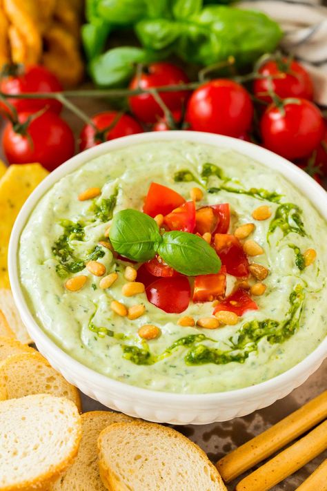 This pesto dip is a blend of mayonnaise, sour cream, basil pesto and seasonings that are combined to create a rich and creamy dip in just minutes. The easiest last minute appetizer option that pairs well with bread, veggies or can even be used on a sandwich or as a salad dressing. Pesto Appetizers, Christmas Appetizer Recipes, Cold Dip, Cold Dip Recipes, Pesto Dip, Thanksgiving Appetizer, Christmas Appetizer, Thanksgiving Appetizer Recipes, Bacon Deviled Eggs