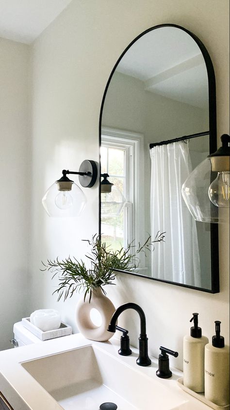 neutral bathroom bathroom decor greenery Black Grey And Cream Bathroom, Neutral Bathroom Black Accents, Black White Neutral Bathroom, Black And White Bathroom With Greenery, Neutral Guest Bathroom, Neutral Powder Room, Transitional Bathroom Black Vanity, Bathroom Neutral Colors, Cheap Renovations