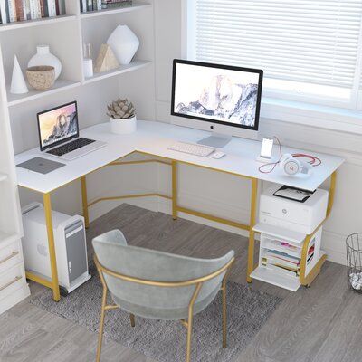 This clean-lined L-shaped desk offers a sleek industrial look and a modern, mixed-material design. The frame is crafted from steel and the tabletop and two convenient shelves are made from engineered wood in a striking hue. Designed for multi-purpose use, this desk is ideal for gaming, working from home, or writing the next great novel. Plus, it even boasts reversible orientation, so it's easy to incorporate into spaces of all configurations. Color (Top/Frame): White/Gold, Size: 29.3" H x 61" W Wood Computer Desk, L Shape Desk, Desk Wood, Bookshelf Storage, Office Guest Room, Corner Table, Austin Design, L Shaped Desk, Home Office Setup