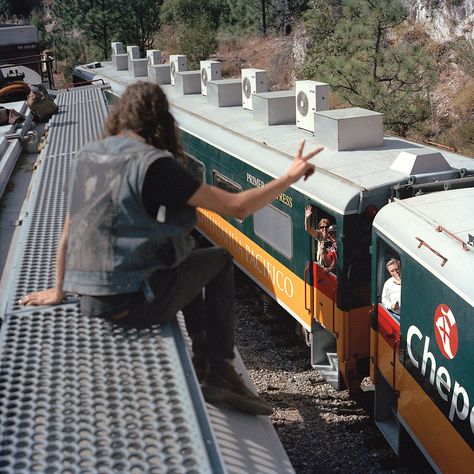 A person on top of a freight train waves to passengers on a train below Rail Car, Bus Tickets, Creature Comforts, Graffiti Artist, Down South, A Train, National Geographic, Dream Life, Surfing