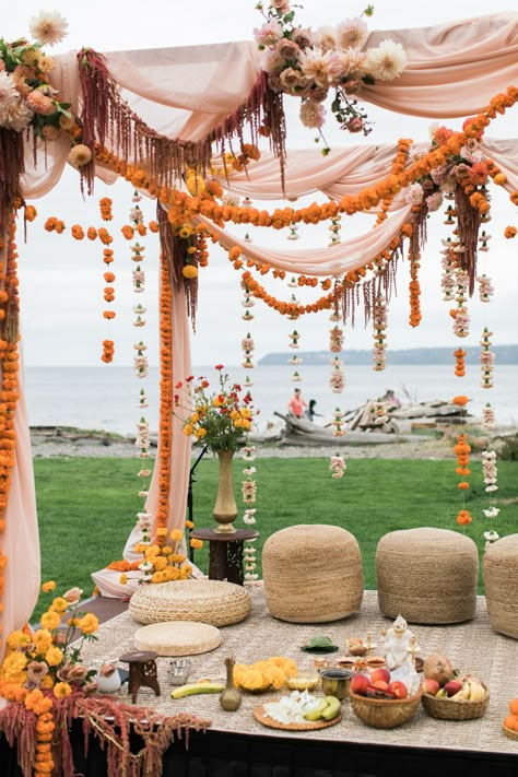 Marigold garlands, carnations, hanging amaranthus, cafe au lait dahlias and koko loko garden roses with draped fabric ceremony mandap flower design. Marigold Mandap Decoration, Backyard Indian Wedding, Mandap Flowers, Maiyan Ceremony, Indian Wedding Florals, Garden Indian Wedding, Mandap Backdrop, Indian Wedding Outside, Colorful Wedding Ceremony Decor