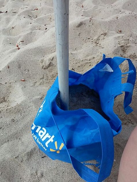 my home made umbrella sand anchor could nt find any at walmart or homedepot so made one with a walmart bag just cut a whole at the bottom put the tube trough it uck the tube deep n tge sand and filled the bag with sand to keep the umbrella sturdy Beach Umbrella Hack, Diy Sandbags, Walmart Bag, Beach Umbrella Anchor, Beach Life Hacks, Charleston Beaches, Fl Beaches, Beach Cart, Diy Shades