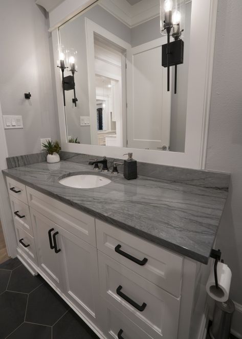 The dark gray veining of bondi quartzite looks really good with black accents. White Cabinet Grey Countertop Bathroom, Gray Bathroom Countertop Ideas, Bathroom With Grey Countertop, Bathroom Decor Gray And Black, Slate Gray Bathroom Vanity, White Vanity With Grey Countertop, Gray Countertops Bathroom Quartz, Dark Gray Marble Countertops, Bathrooms With Gray Countertops