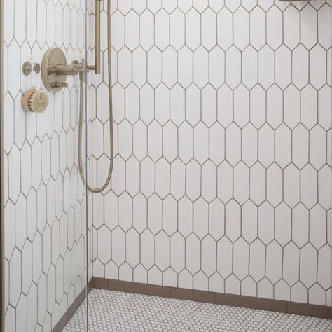 Recreate this fabulous shower for your new bathroom remodel.  It's comprised of three patterns and the brown subway it the frame where the elongated hex tile meets the penny round tile.   Please see the carousel for closeups of the three tile design that make up this shower.  
This shower inspiration is part of the Bathroom in a Box Crewe Design Collection.  The rest of the products to complete the bathroom remodel are shown with links on where to purchase. Penny Stone Tile Bathroom, Hex Tile Bathroom Wall, Primary Bathroom Shower Tile, Penny Tile In Bathroom, Penny Round Bathroom Floor, Penny Round Tile Bathroom Floor, Picket Tile Bathroom, Penny Round Tile Bathroom, Tile In Bathroom