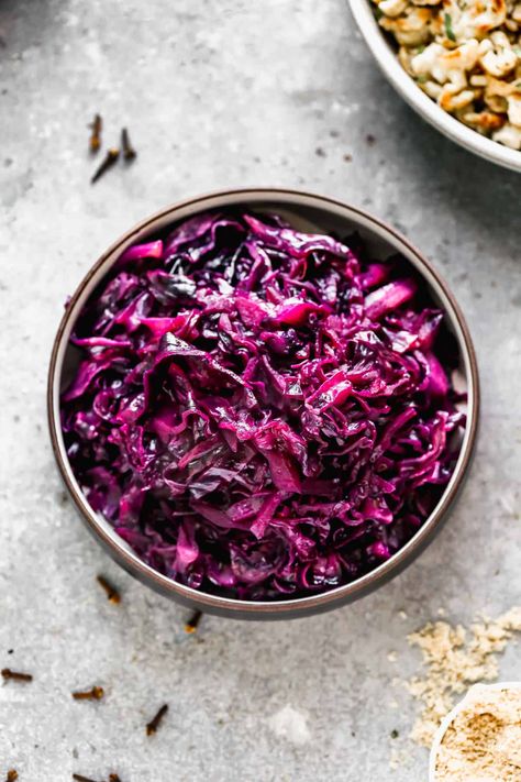 This braised German Red Cabbage recipe (Rotkohl) is as traditional as it gets and never absent at German festivals or restaurants. It’s sweet and sour flavor comes from brown sugar, vinegar and apple. Whole cloves add to its unique flavor and aroma. For a complete meal make German Red Cabbage with Rouladen and Spaetzle. It’s… Spiced Red Cabbage, German Red Cabbage, Red Cabbage With Apples, Sweet And Sour Cabbage, Pickled Red Cabbage, Sour Cabbage, Red Cabbage Recipes, Braised Red Cabbage, Pickled Cabbage