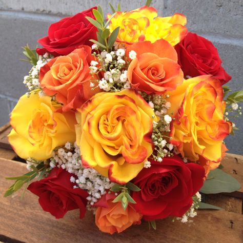 Red, yellow, and orange roses arranged in a bridal bouquet. Simple, colorful, and classy for a fall ceremony. Orange And Red Roses Bouquet, Red Orange And Yellow Flowers, Yellow And Orange Roses Bouquet, Yellow And Orange Bouquet, Mcdonalds Wedding, Orange Quinceanera, Wedding Bouquet Yellow, Quinceañera Planning, Yellow Rose Wedding