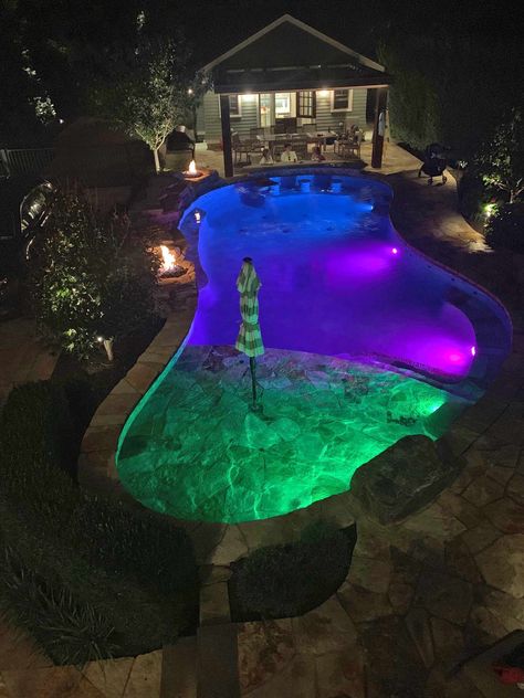 Landscape lighting, fire pits, LED pool lights, swim up bar, beach entry, bubblers Pool With Led Lights, Pool With Lights At Night, Led Pool, Pool Lights At Night, Pool Lighting Ideas, Pool Decorating Ideas, Inground Pool Lights, Backyard Splash Pad, Underwater Pool Light