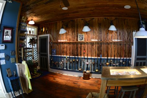 The perfect fishing rod storage in this custom tackle room.  The pecky cypress wall works beautifully with the rich blue wainscoting. Old Florida Fish Camp Decor, Fishing Room Ideas, Fly Fishing Room, Fishing Storage Ideas, Fishing Workshop, Fishing Tackle Room, Blue Wainscoting, Fishing Room Decor, Fishing Man Cave