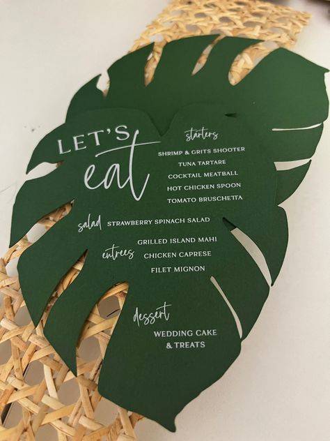 Calling all tropical plant lovers 🌴:These monstera menus are the coolest element you can add to any events table! Pairs nicely with a colorful napkin and is bound to make your guest excited to eat! 🪴💗🙌🏽   #wilmingtonnc #customweddinginvitations #custominvitations #weddingdetails #weddingdesign #stationerydesign #weddingstationery #weddingplanning #weddinginspiration #weddinginspo #weddingideas #stationery #weddingdecor #modernwedding Wedding Invitations Tropical Theme, Tropical Wedding Stationery, Tropical Menu Design, Monstera Wedding, Menu Table, Tropical Wedding Theme, Thailand Beach, Green Wedding Inspiration, 30th Party