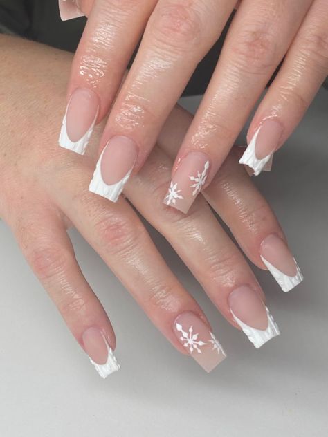 It can be anything, as long as it's holiday-themed! Winter Christmas Nails French Tip, French Tips Nails Christmas, French Tip Nails With Design Winter, French Tip Nail Designs Christmas, White Christmas Nails French Tips, French Tip Nails Christmas Simple, White French Snowflake Nails, White French Tip With Snowflake On Ring Finger, French Tips With Christmas Design