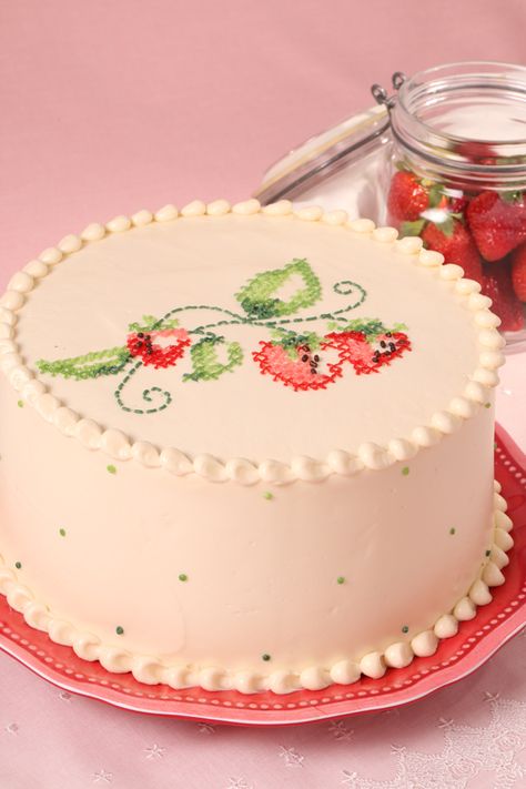 Buttercream is used to decorate a cake replicating traditional cross stitch strawberry motif. Strawberries, Cross Stitch, Pastel, Cake