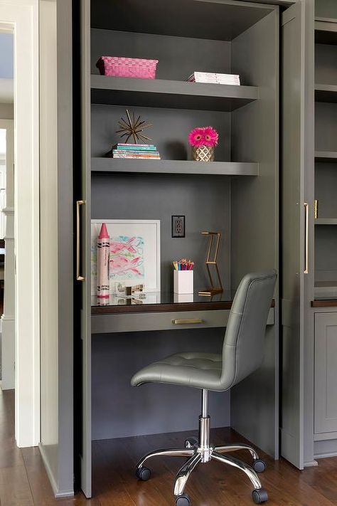 A small gray closet with folding doors open to a built-in desk with upper shelves and a gray swivel leather chair. Desk In Closet, Inside Wardrobe, Built In Desk And Shelves, Gray Closet, Hidden Desk, Closet Desk, Desk Nook, Home Office Closet, Kitchen Desks