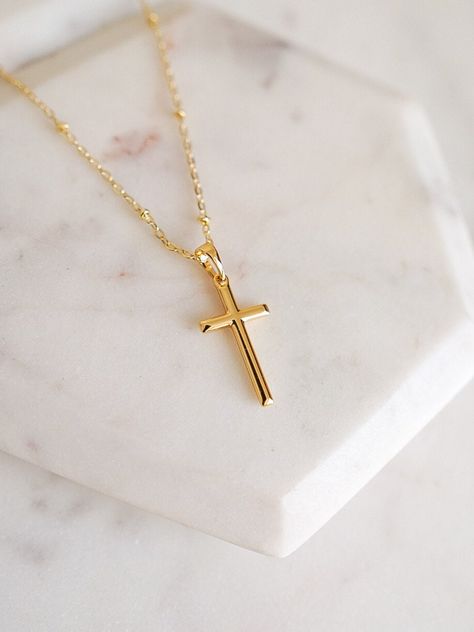 Our simple gold cross necklace is designed with a small gold cross pendant hanging from a delicate gold satellite chain. This dainty gold necklace is perfect for layering and would make the perfect gift for any religious occasion such as baptism, first communion, confirmation or birthday.  DETAILS:   - 14k gold filled dainty satellite chain 17 inches w. 2 inch extender  - 14k gold filled small gold cross pendant 1 inch length  - Handcrafted with love and good vibes in Miami, FL  - Pre-packaged f Small Gold Cross Pendant, Gold Cross Jewelry, Birthday Details, Cross Necklace Gold, Schmuck Gold, Cross Charm Necklace, Faith Necklace, Cute Engagement Rings, Magical Jewelry