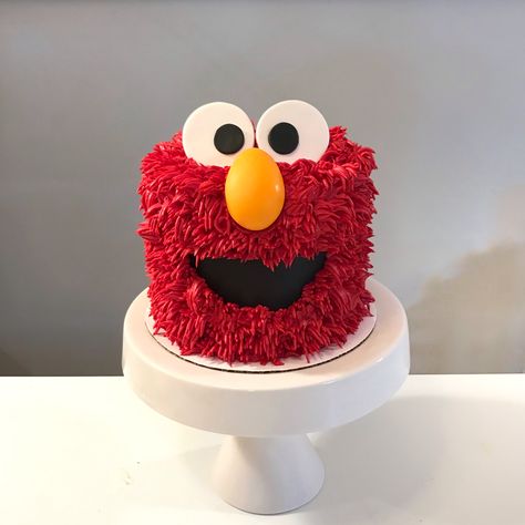 Fuzzy Elmo cake!  Achieved by using large grass tip and red buttercream. Fondant accents. Sesame Street Buttercream Cake, Elmos World Birthday Cake, Elmo Cake Diy, Buttercream Sesame Street Cake, Elmo Cake Ideas, Elmo Smash Cake Boy, Elmo Cake For Boys, Sesame Street Smash Cake, Elmo Smash Cake