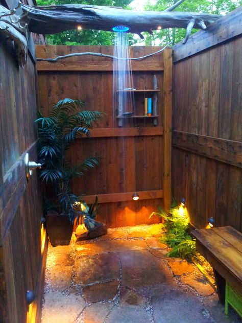 outdoor shower we built out of repurposed lumber. 1950 garage door, also drift wood logs, and sandstone rock found in a pile. Cabin Outdoor Shower Ideas, Outdoor Shower Rustic, Pallet Shower Outdoor, Outdoor Shower House, Outdoor Shower Sauna Combo, Boho Outdoor Shower Ideas, Beach Outdoor Shower Ideas, Outside Toilet Ideas Outdoor Bathrooms, Backyard Shower Ideas