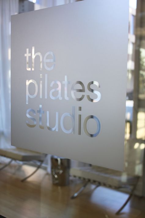 pilates Signage On Glass Door, Frosted Logo On Glass Door, Pilates Studio Signage, Yoga Studio Sign, Window Signage Ideas, Indoor Signage Design, Pilates Logo Ideas, Pilates Sign, Glass Door Signage