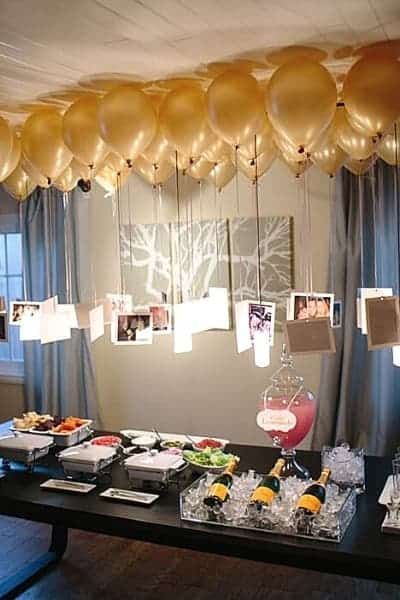 Pictures Hanging from Balloons at Party (1) Pictures Hanging From Balloons, Simple Party Decor, Work Retirement Party Ideas, Birthday Photo Displays, Picture Display Ideas, Birthday Party For Men, Birthday Party Ideas For Adults, Photo Centerpieces, Wedding Party Games