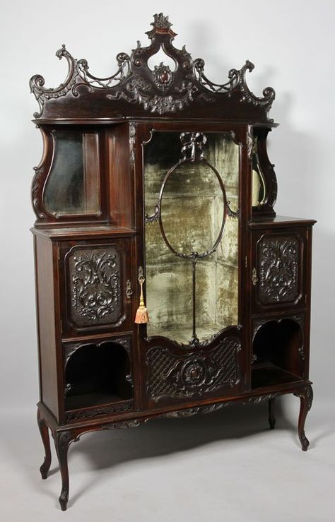 Late Victorian Carved Dark Mahogany Display/Side Cabinet, The Molded Cornice Above A Glazed Cupboard Door With Ribbon Tired Oval Central Panels And Blind Fret Lattice Work Panel To The Base, Enclosing A Pale Green Plush Lined Interior, Flanked By A Pair Of Open Shelves With Shaped Bevel Edge Mirrors To The Back, Vintage Bedroom Furniture, Painting Wooden Furniture, Mahogany Cabinets, Victorian Interiors, Gothic Furniture, Dark Mahogany, Victorian Furniture, Vintage Bedroom, Victorian Decor