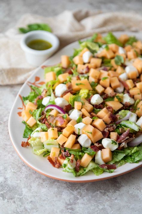 A scrumptious summer salad or side, this cantaloupe salad has a basil honey dressing and is topped with fresh mozzarella and bacon. Healthy Sides For Burgers, Cantaloupe Salad, Side Braid Tutorial, Cantaloupe Smoothie, Cantaloupe Recipes, Honey Dressing, Small Food Processor, Olive Oils, Just Eat It